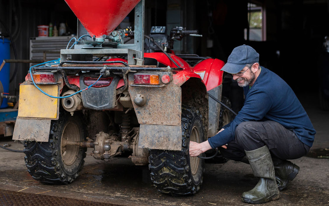 A farmer working on a machine