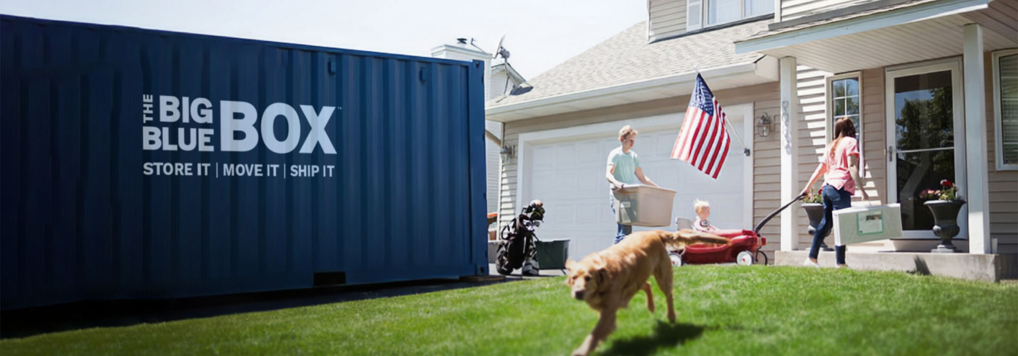 A house with a blue storage container in the driveway with a family outside