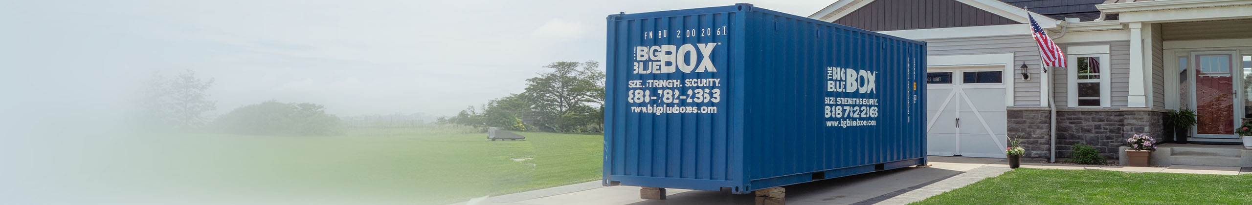 A Big Blue Box storage container in the driveway of a house