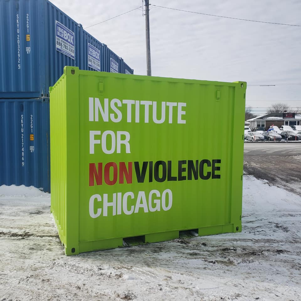 A green storage container with messaging - Institute for nonviolence chicago