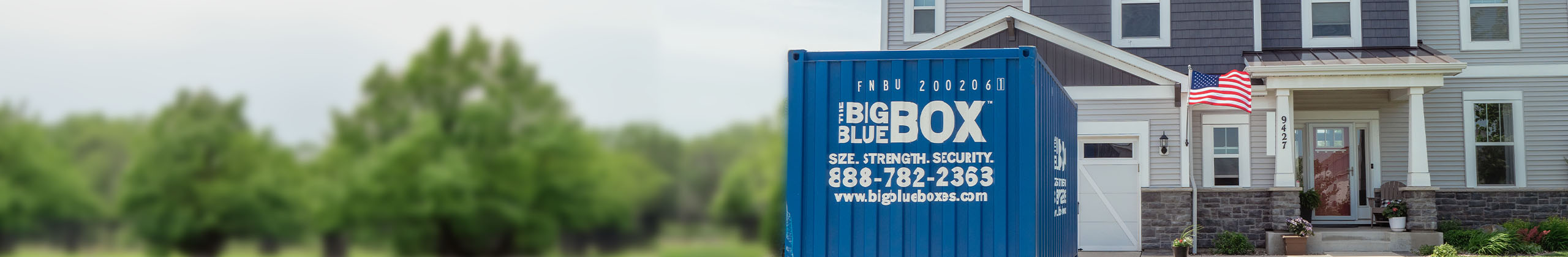 A Big Blue Box storage container in front of a house