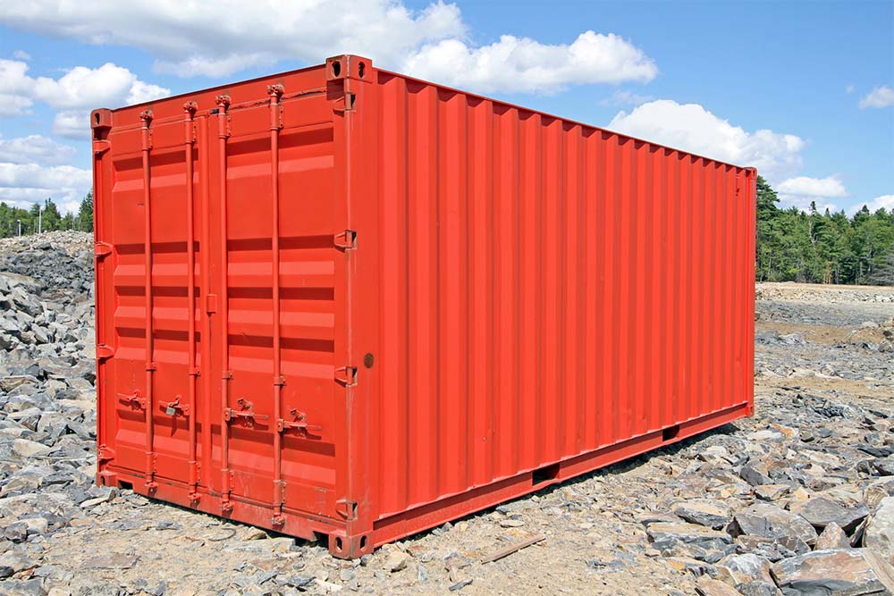 A red storage bin on rocks