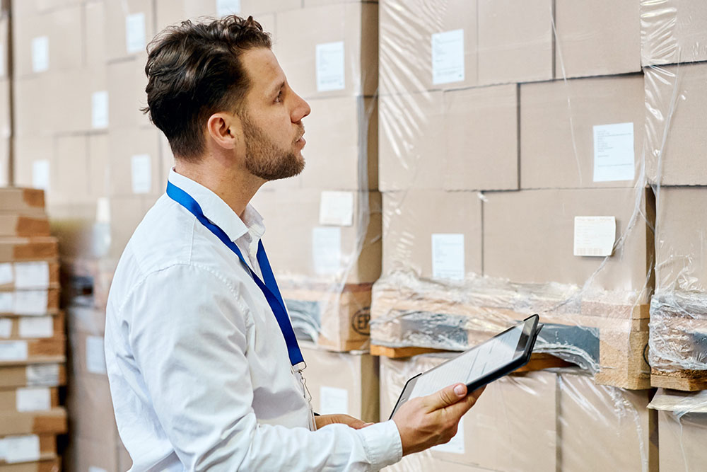 A worker looking at moving boxes