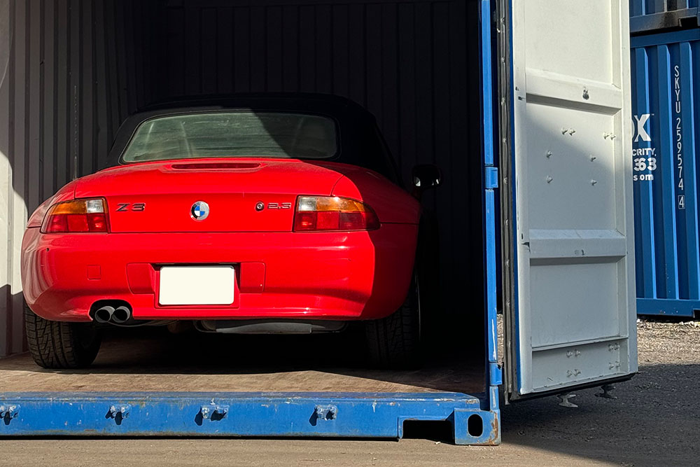 A red BMW inside a storage container