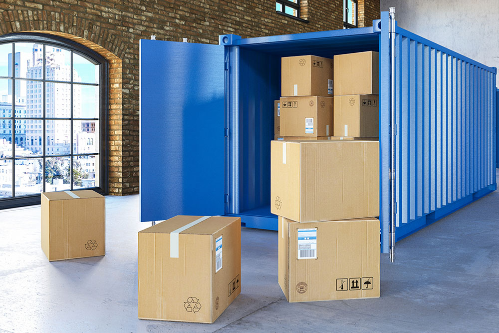 A blue storage container in a loft with moving boxes inside